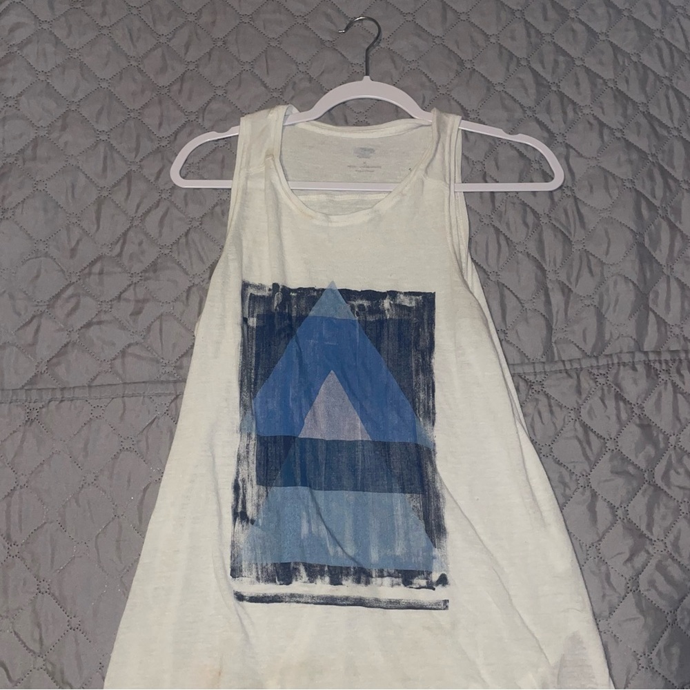White tank top with blue triangle design.